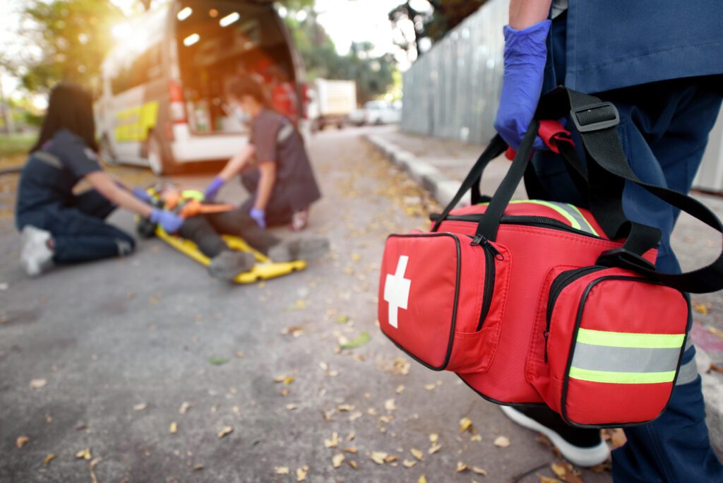 Emergency first aid team service for an accident with a many laying on a stretcher.